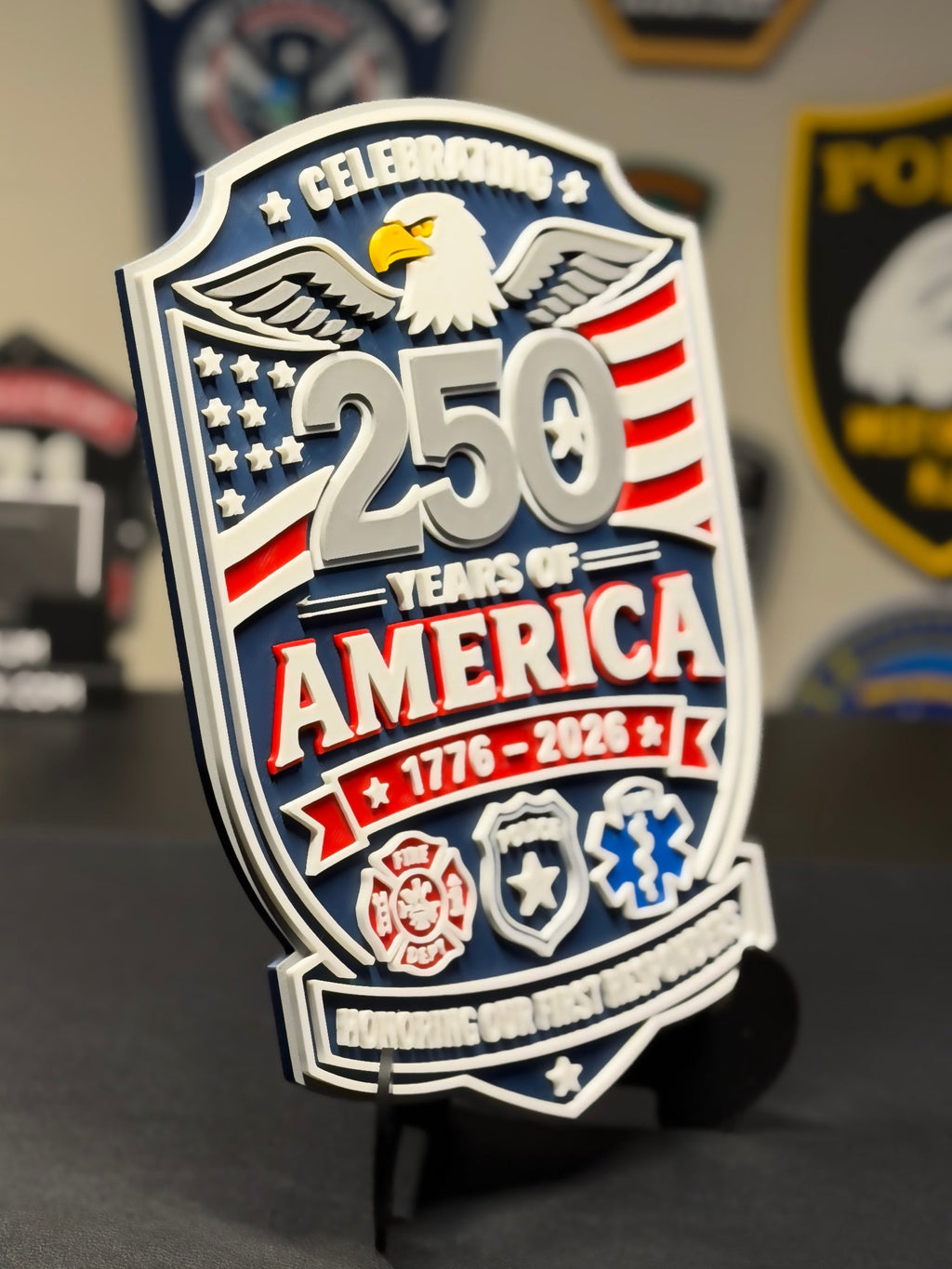 Decorative plaque celebrating 250 years of America on a stand with various emblems in the background.